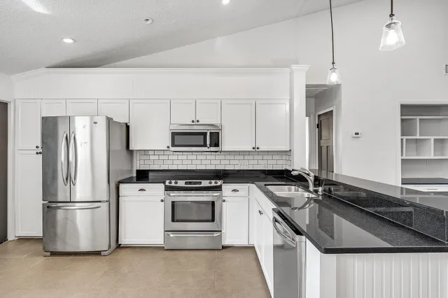 a kitchen with a sink stove and refrigerator