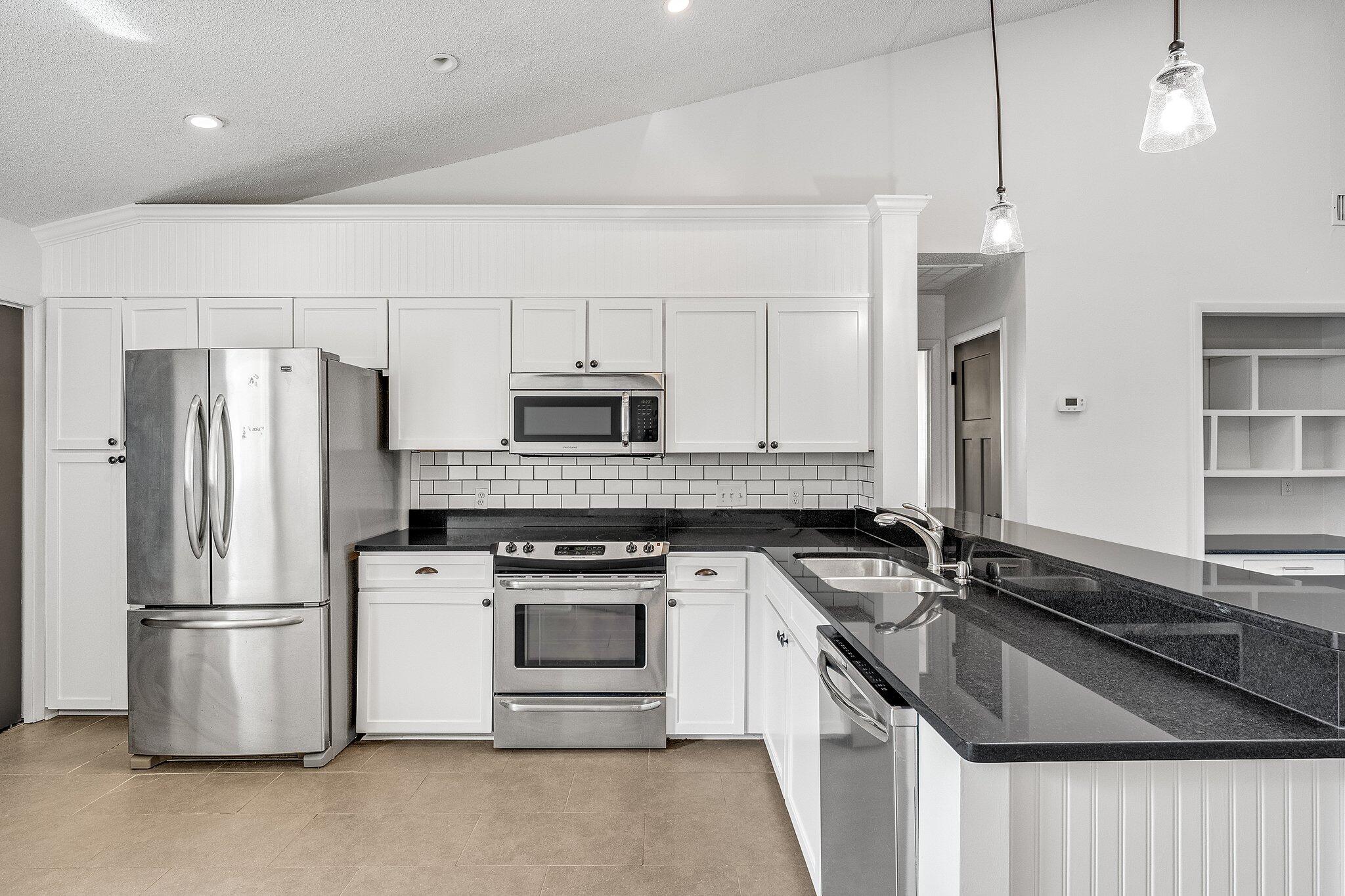 8983 Heron Walk Drive, Unit 8983 Miramar Beach, FL 32550 - Photo 5 of 57 a kitchen with a sink stove and refrigerator