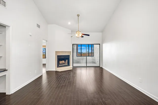 a view of a room with window and wooden floor