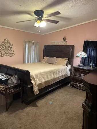 a bedroom with a bed and a flat tv screen