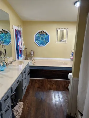 a bathroom with a toilet sink and mirror