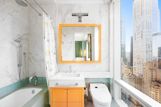 a bedroom with furniture and large windows