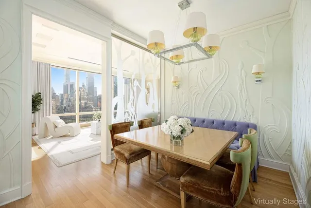 a view of dining room with wooden floor and a chandelier