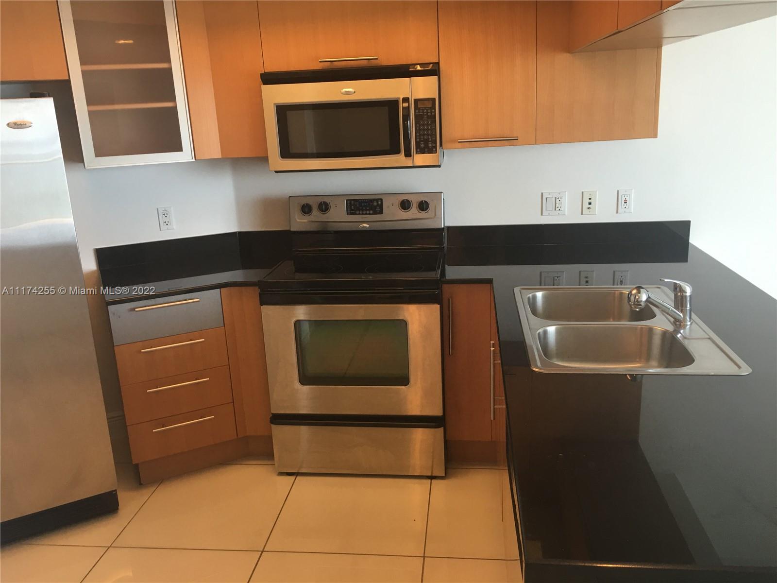 Edgewater Miami, FL 33132 - Photo 8 of 14 a kitchen with a sink and a microwave