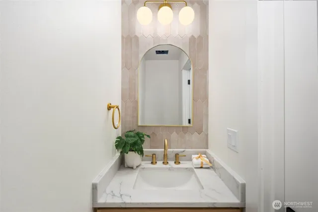 a bathroom with a sink a mirror and a window