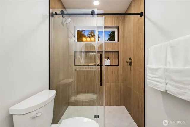 a bathroom with a shower and toilet