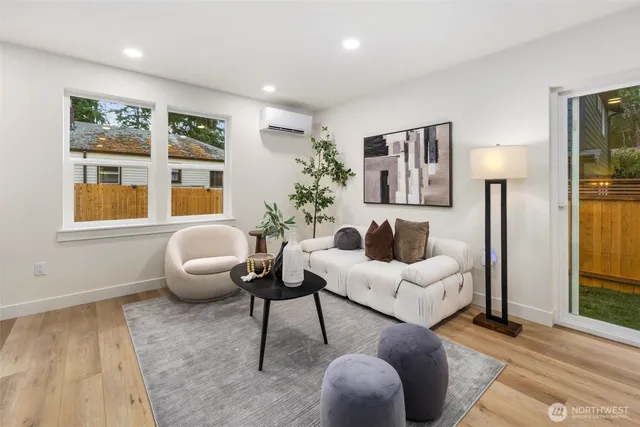 a living room with furniture potted plant and window