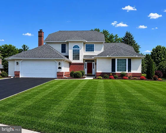 a front view of house with yard and green space
