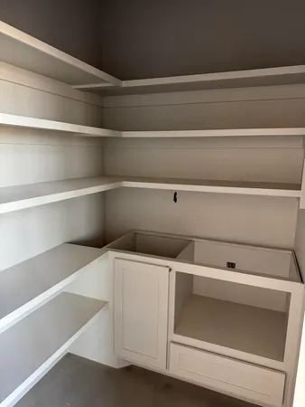 a view of an empty room and a window