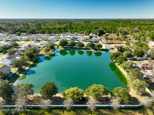 a view of a backyard with swimming pool