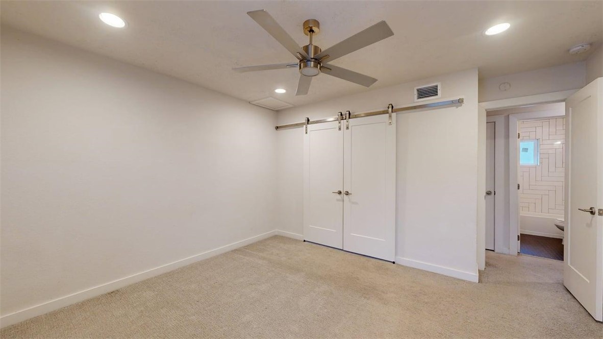 505 Boyett Street, Unit D1 College Station, TX 77840 - Photo 13 of 23 an empty room with a ceiling fan and a window