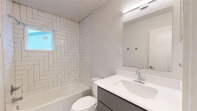 a bathroom with a sink toilet tub and shower