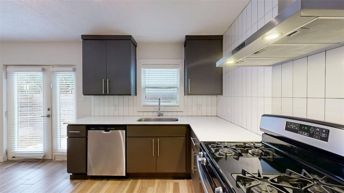 505 Boyett Street, Unit D1 College Station, TX 77840 - Photo 6 of 23 a kitchen with a stove and a sink