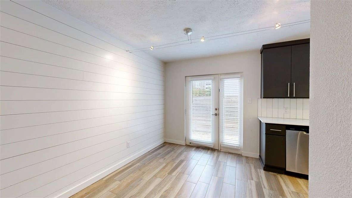 505 Boyett Street, Unit D1 College Station, TX 77840 - Photo 8 of 23 a view of empty room with wooden floor and fireplace