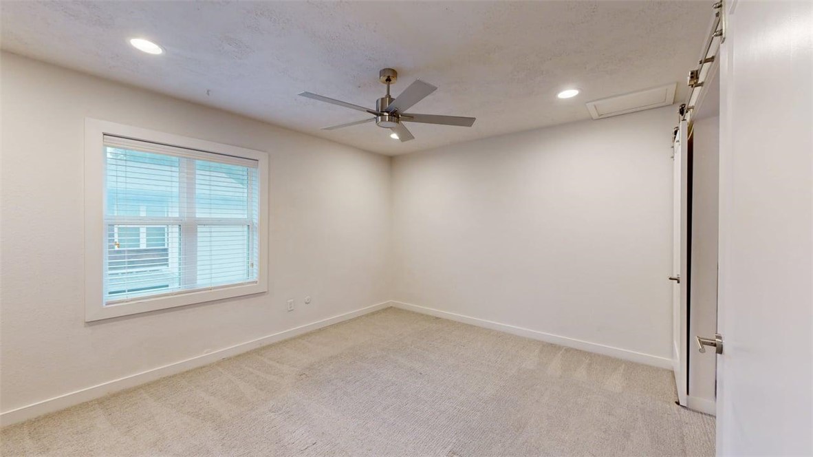 505 Boyett Street, Unit D1 College Station, TX 77840 - Photo 10 of 23 an empty room with a window and a fan