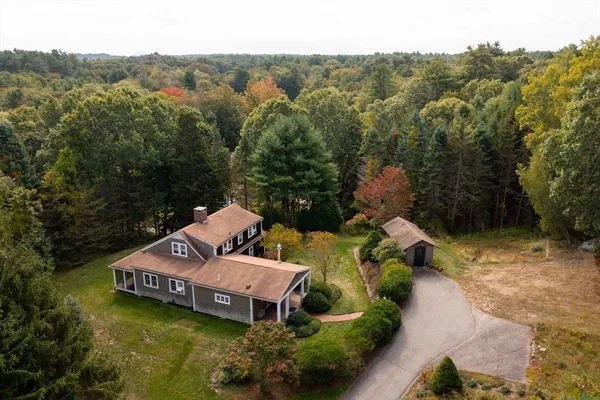 an aerial view of a house with swimming pool and a yard