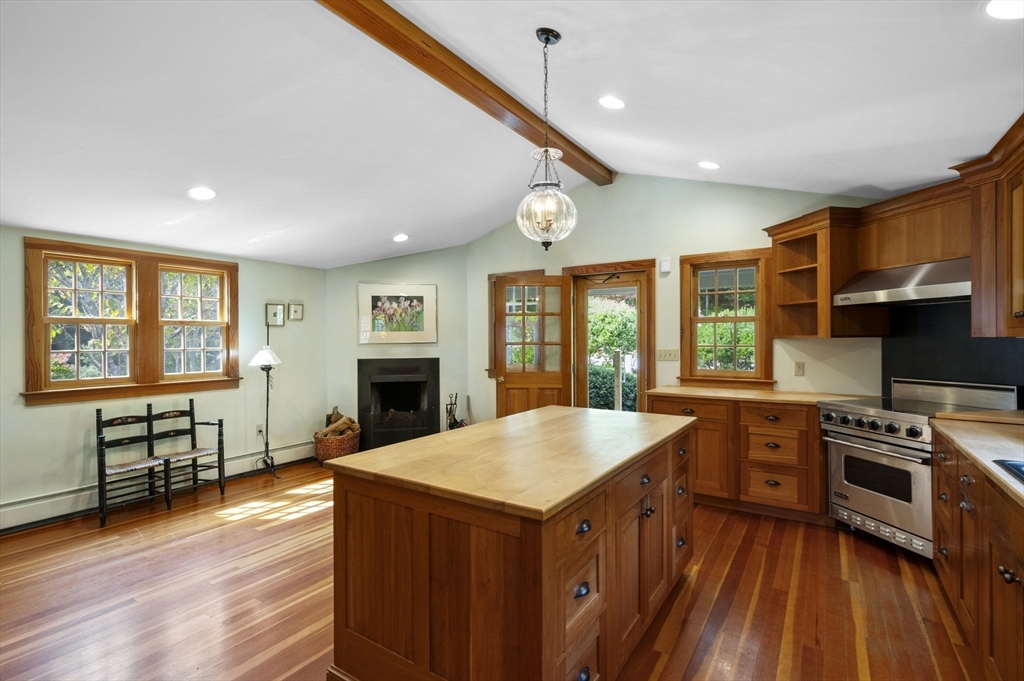 431 Moraine Street Marshfield, MA 02050 - Photo 8 of 38 a kitchen with stainless steel appliances granite countertop a stove top oven a sink dishwasher a refrigerator and a dining table with wooden floor