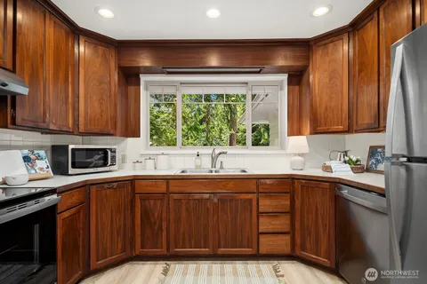a kitchen with a sink stove and cabinets