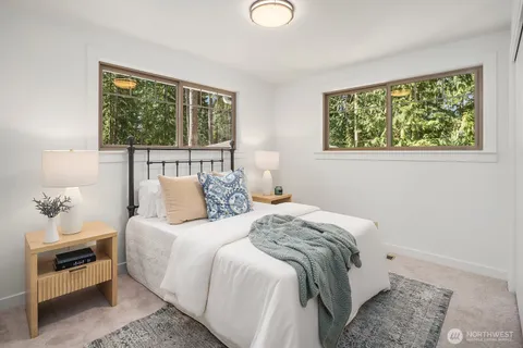 a bedroom with bed and a window