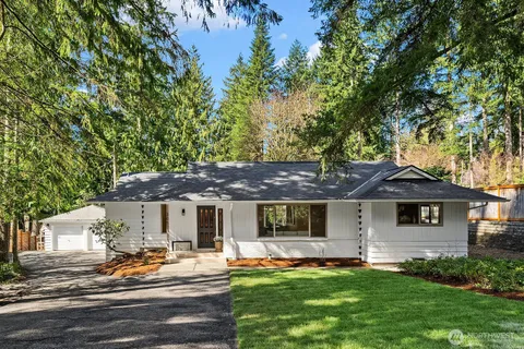 a front view of a house with a garden and patio