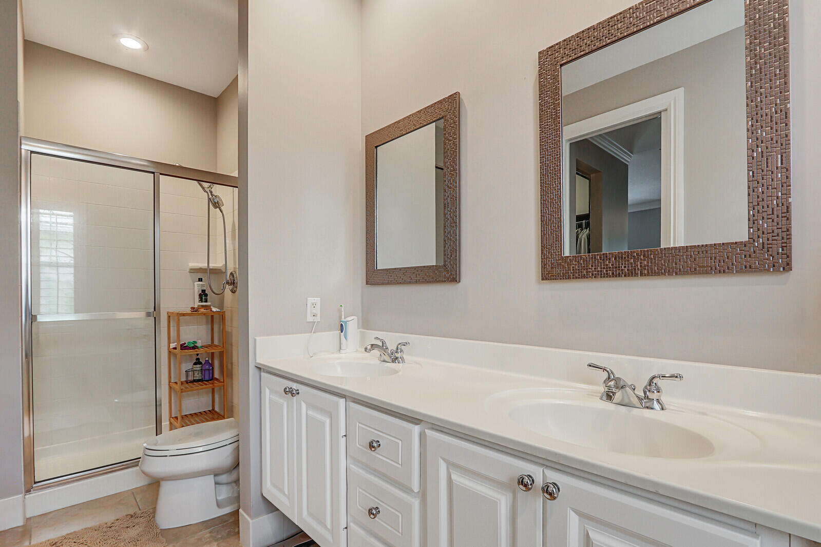 101 St Pierre Way Jupiter, FL 33458 - Photo 31 of 57 a bathroom with a double vanity sink toilet and mirror