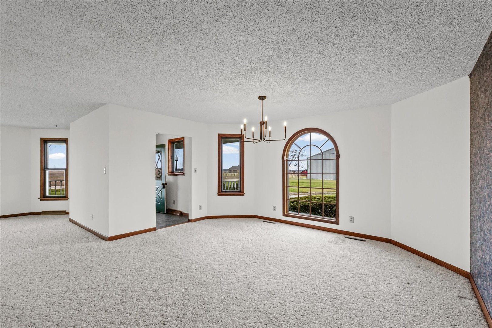 7961 North 3000 E Road Forrest, IL 61741 - Photo 9 of 66 an empty room with chandelier fan and windows