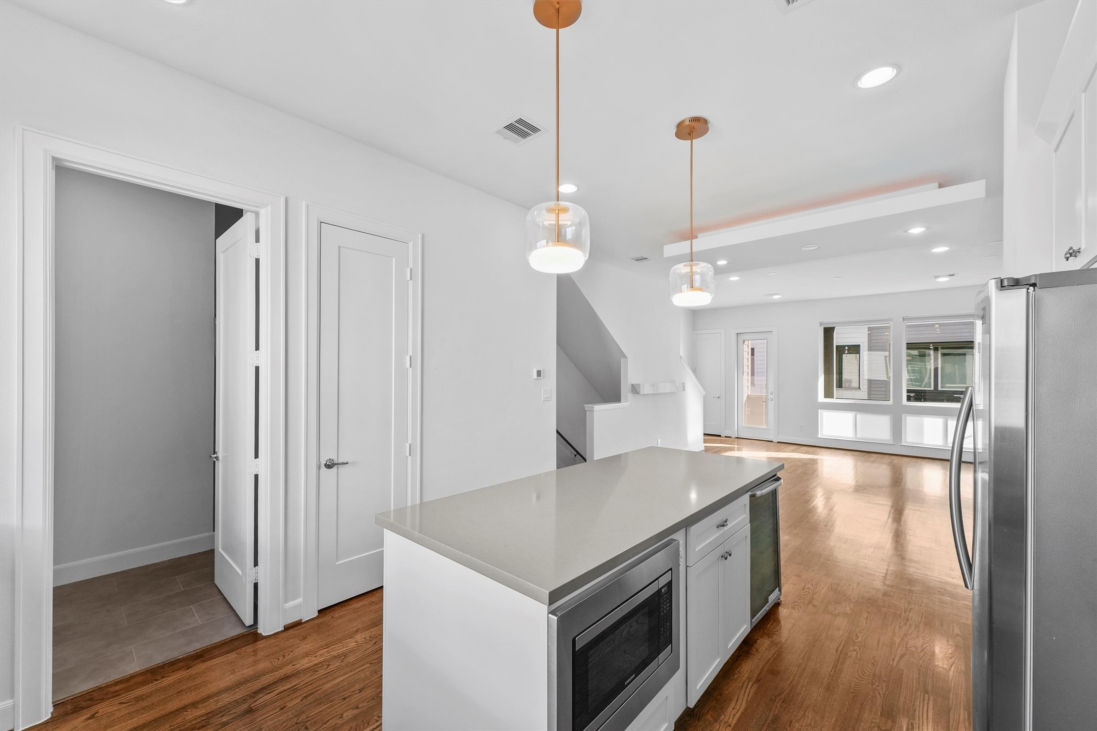 1050 Timbergrove Yards Lane Houston, TX 77008 - Photo 10 of 33 a kitchen with a stove a sink a center island with wooden floor