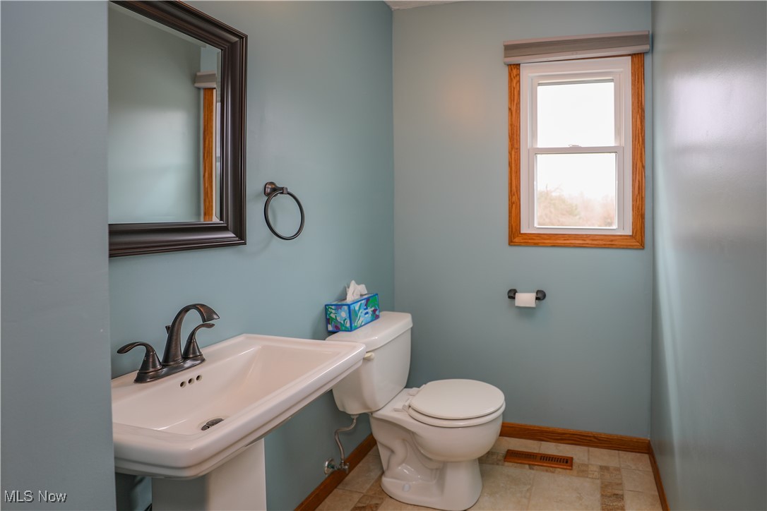 12565 Alpha Road Hiram, OH 44234 - Photo 19 of 50 Half bath featuring toilet, baseboards, and a sink