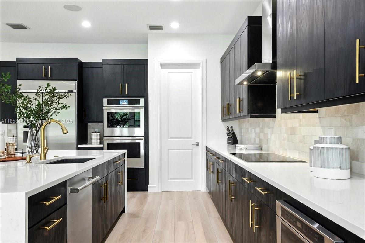 17819 Southwest 58th Street Southwest Ranches, FL 33331 - Photo 14 of 56 a kitchen with stainless steel appliances a sink stove and refrigerator