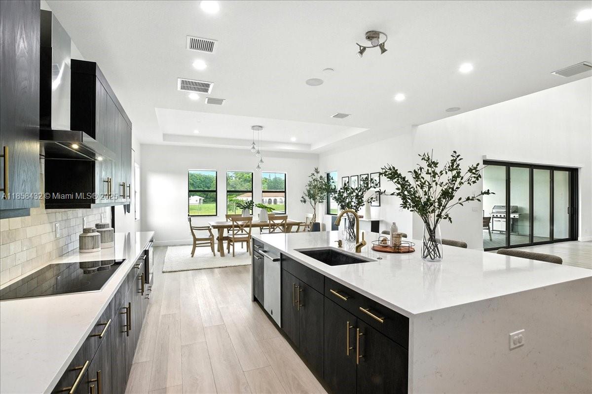 17819 Southwest 58th Street Southwest Ranches, FL 33331 - Photo 15 of 56 a kitchen with sink stove and refrigerator