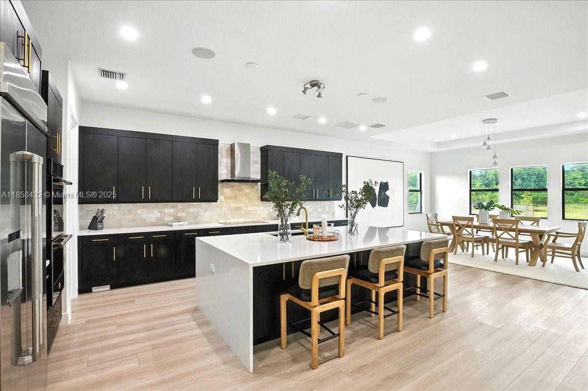 17819 Southwest 58th Street Southwest Ranches, FL 33331 - Photo 16 of 56 a large kitchen with a table and chairs