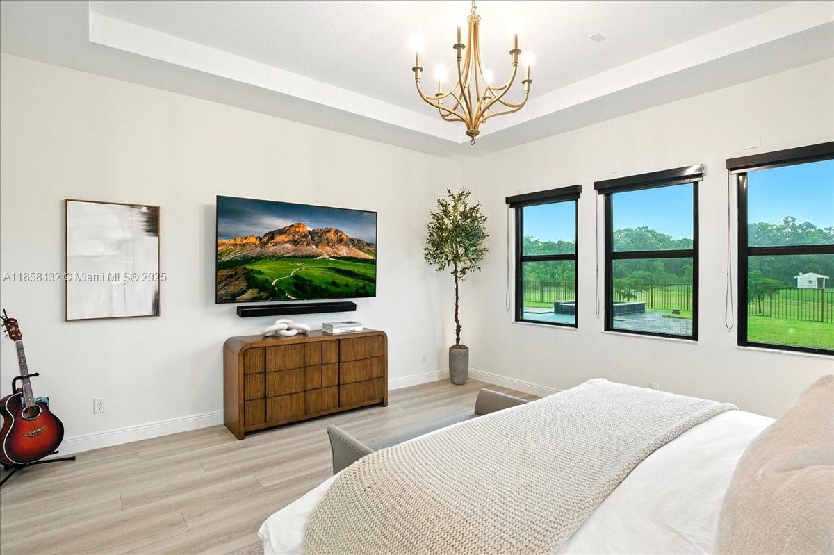 17819 Southwest 58th Street Southwest Ranches, FL 33331 - Photo 21 of 56 a bedroom with furniture and a flat screen tv