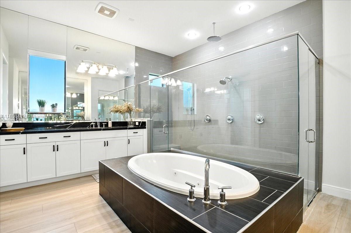 17819 Southwest 58th Street Southwest Ranches, FL 33331 - Photo 23 of 56 a bathroom with a double vanity sink a mirror and a shower