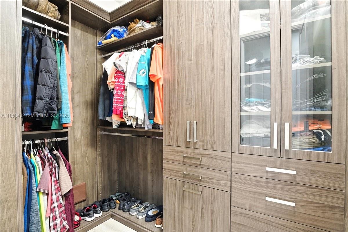 17819 Southwest 58th Street Southwest Ranches, FL 33331 - Photo 26 of 56 a view of walk in closet with clothes and shoes