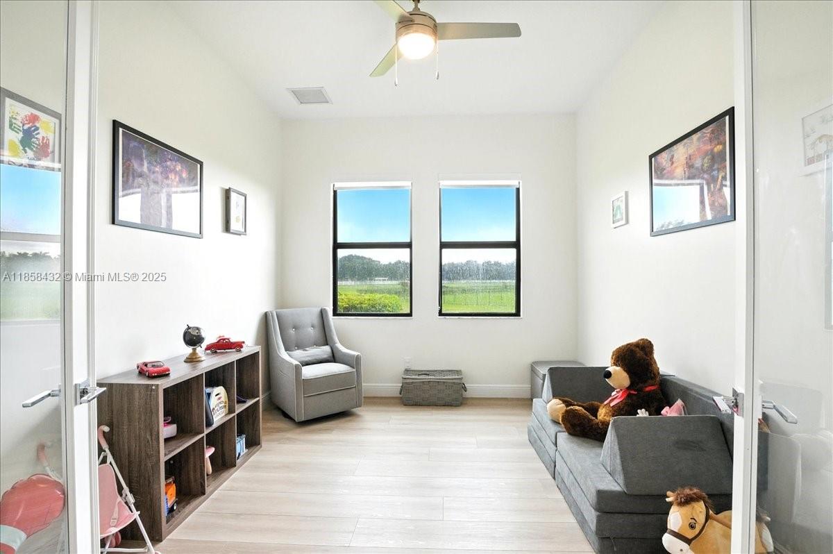 17819 Southwest 58th Street Southwest Ranches, FL 33331 - Photo 28 of 56 a living room with furniture and a window