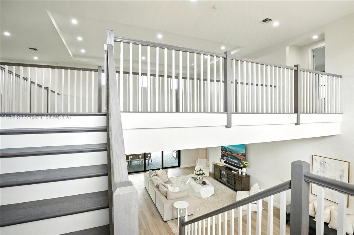 17819 Southwest 58th Street Southwest Ranches, FL 33331 - Photo 30 of 56 a view of a hallway with dining room and stairs