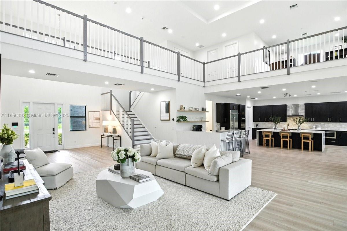 17819 Southwest 58th Street Southwest Ranches, FL 33331 - Photo 3 of 56 a living room with furniture kitchen view and a chandelier