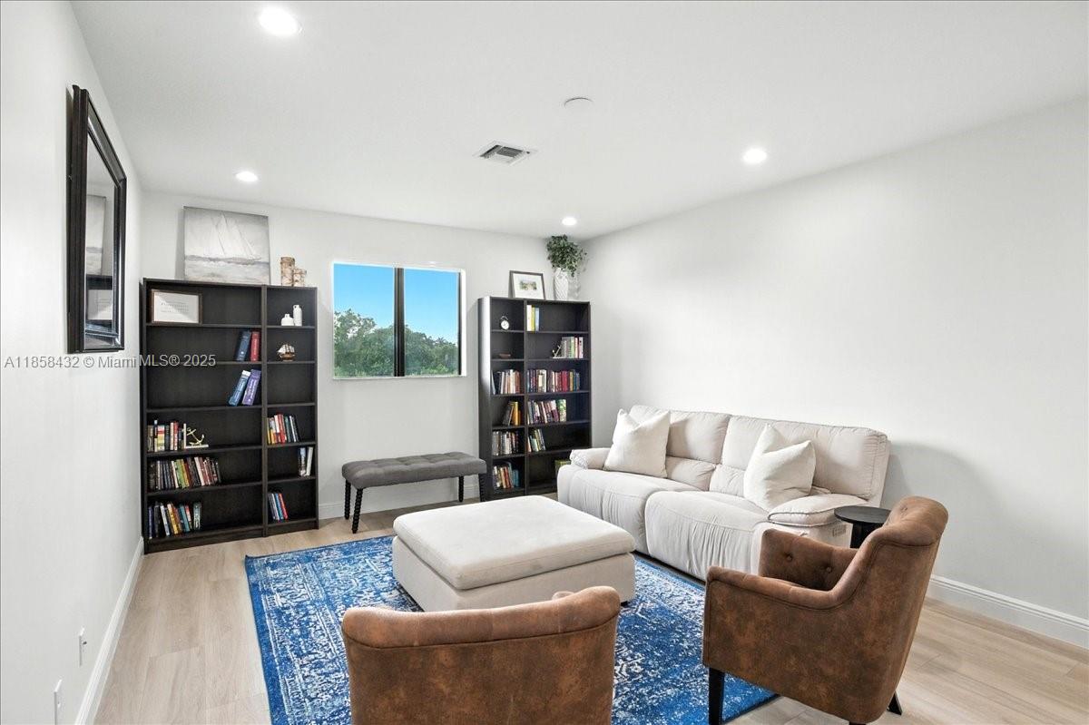 17819 Southwest 58th Street Southwest Ranches, FL 33331 - Photo 32 of 56 a living room with furniture and a wooden floor with rug floor
