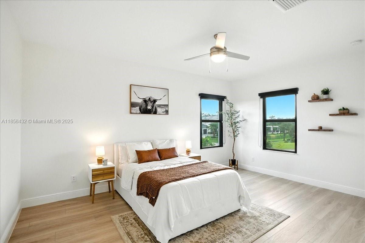 17819 Southwest 58th Street Southwest Ranches, FL 33331 - Photo 35 of 56 a bedroom with a large bed and a window