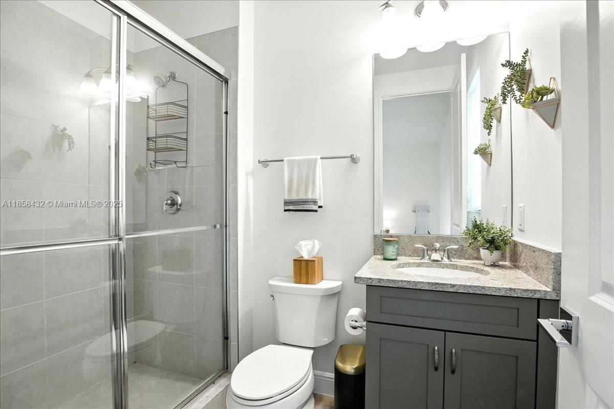 17819 Southwest 58th Street Southwest Ranches, FL 33331 - Photo 36 of 56 a bathroom with a sink a toilet and shower