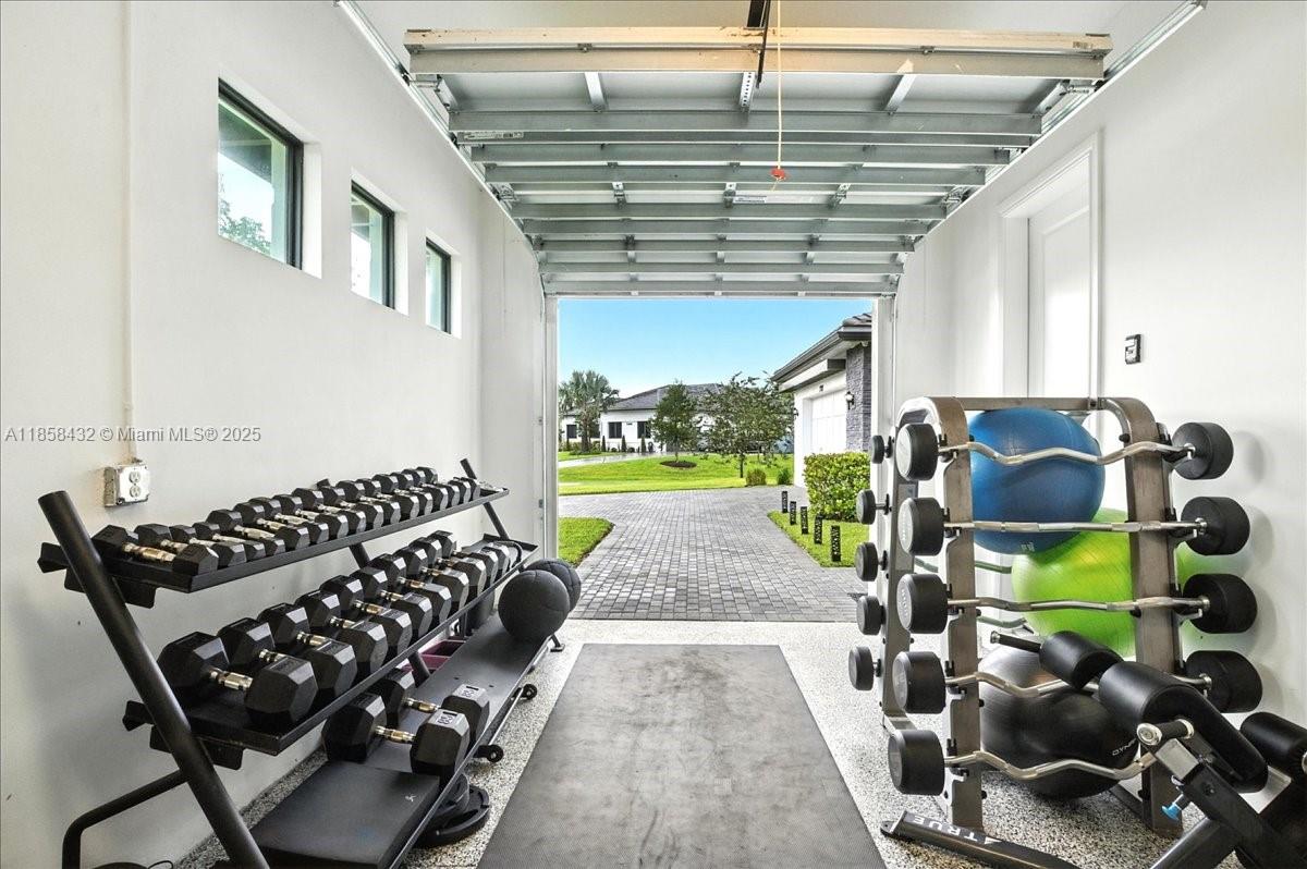 17819 Southwest 58th Street Southwest Ranches, FL 33331 - Photo 42 of 56 a bedroom with furniture and a floor to ceiling window