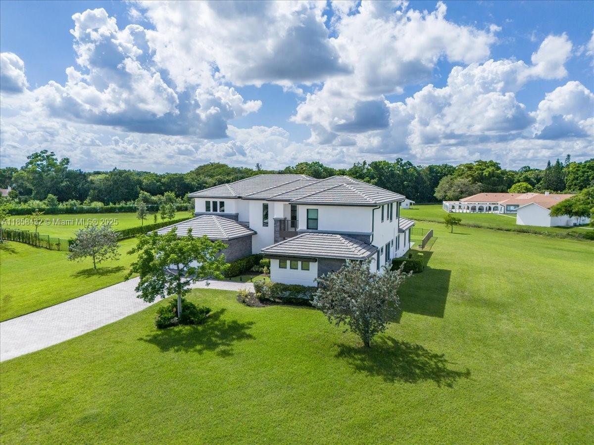 17819 Southwest 58th Street Southwest Ranches, FL 33331 - Photo 43 of 56 a front view of a house with garden