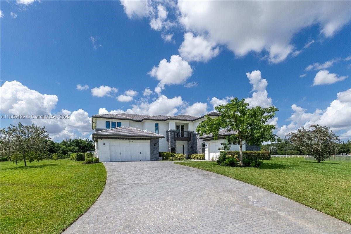17819 Southwest 58th Street Southwest Ranches, FL 33331 - Photo 45 of 56 a front view of a house with garden