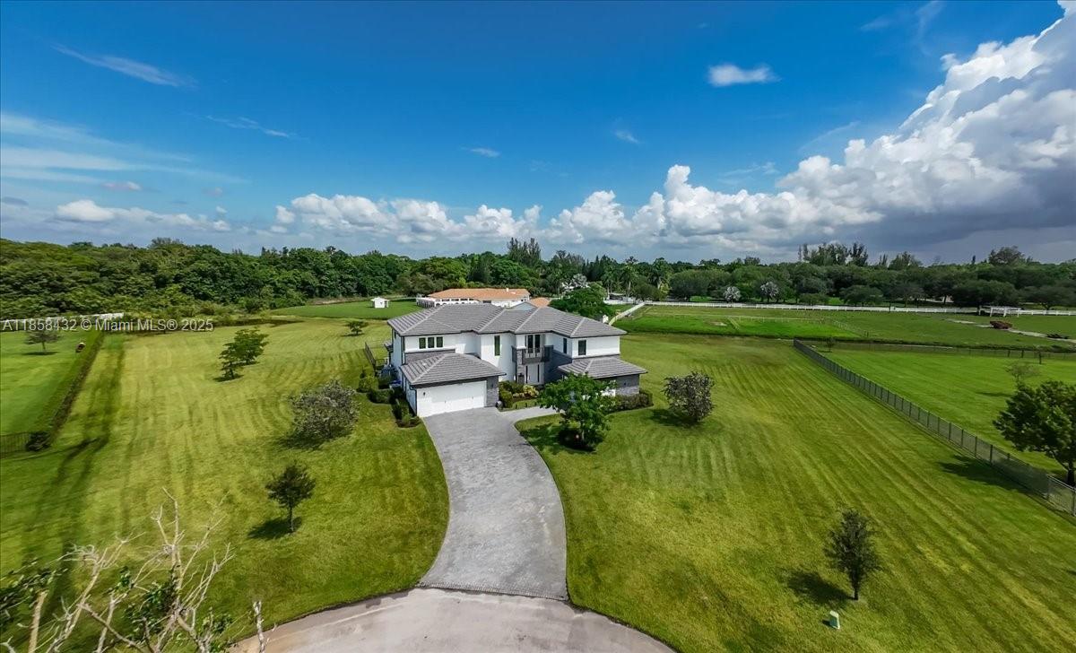 17819 Southwest 58th Street Southwest Ranches, FL 33331 - Photo 49 of 56 a view of a lake with a house in the background