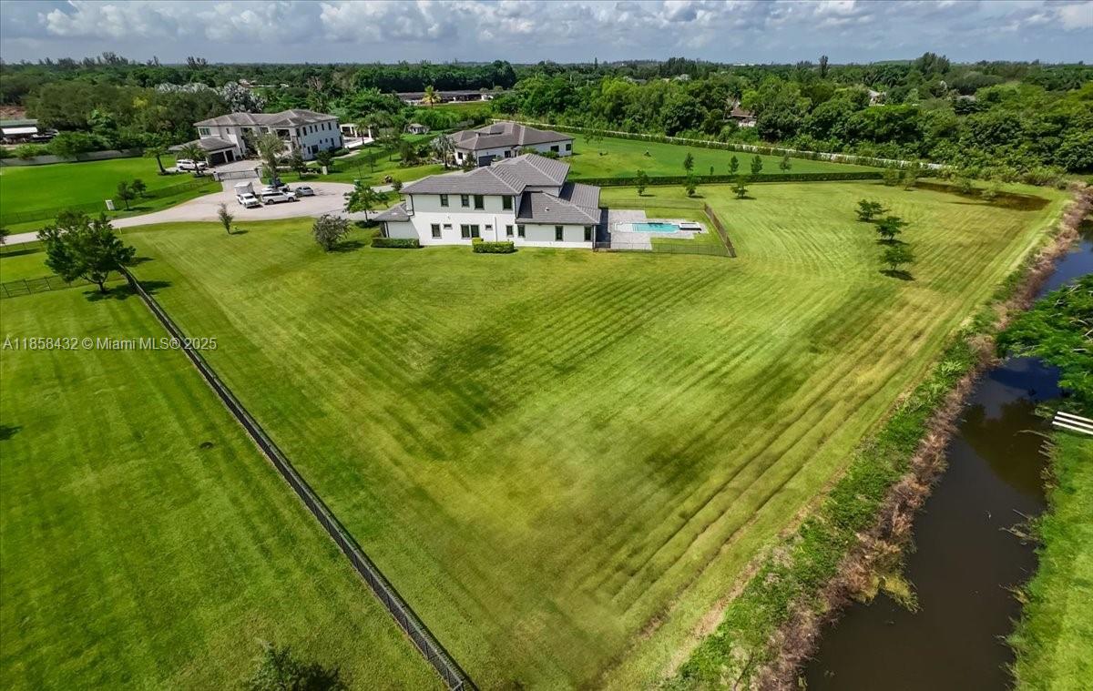 17819 Southwest 58th Street Southwest Ranches, FL 33331 - Photo 50 of 56 a view of a lake with a building in the background