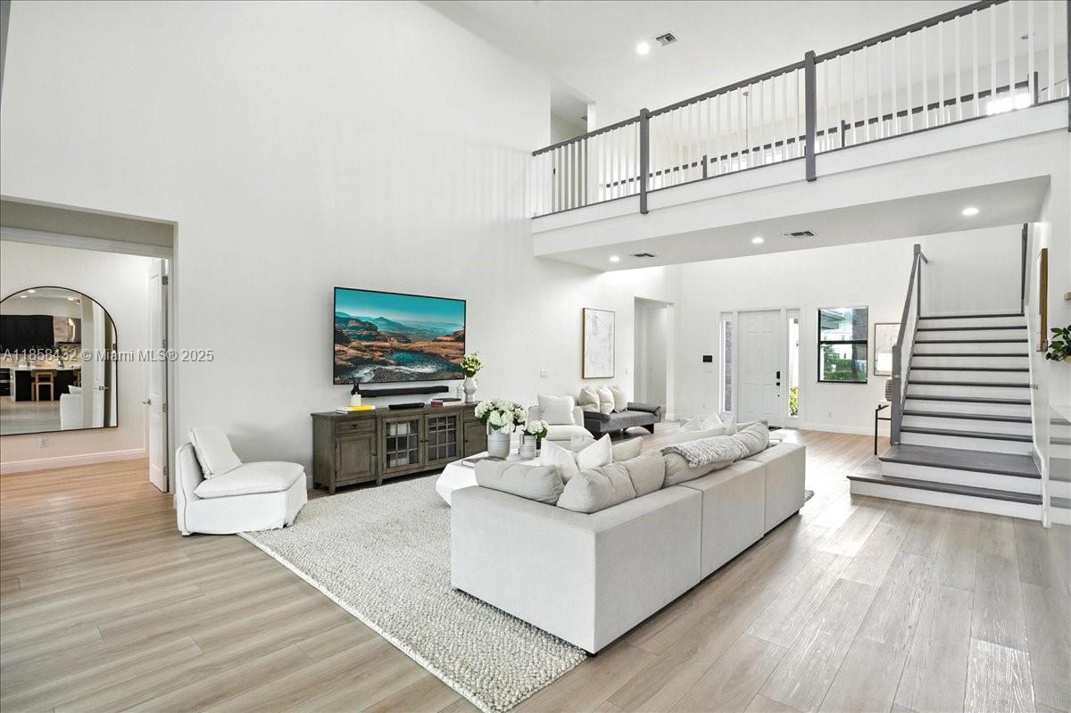 17819 Southwest 58th Street Southwest Ranches, FL 33331 - Photo 8 of 56 a living room with furniture and a wooden floor
