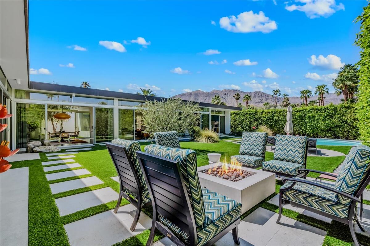 71466 San Gorgonio Road Rancho Mirage, CA 92270 - Photo 38 of 81 a view of a patio with dining table and chairs with a garden