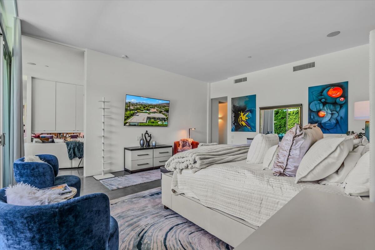 71466 San Gorgonio Road Rancho Mirage, CA 92270 - Photo 45 of 81 a bedroom with a large bed couch and a window