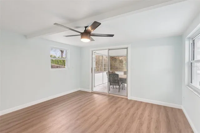 wooden floor in an empty room with a window