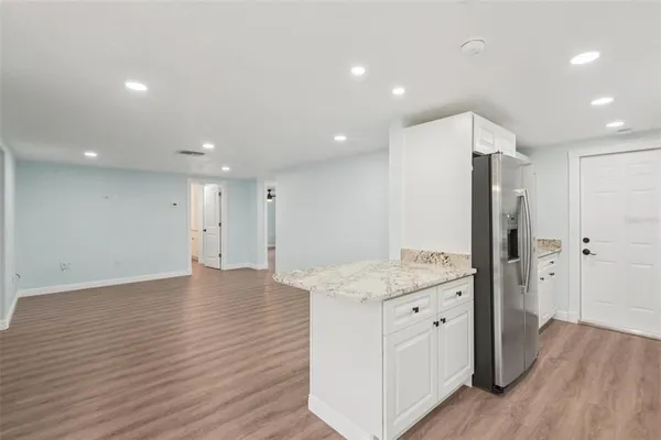 a kitchen with a sink and refrigerator